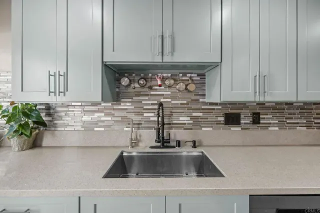 a kitchen with granite countertop a stove and a sink