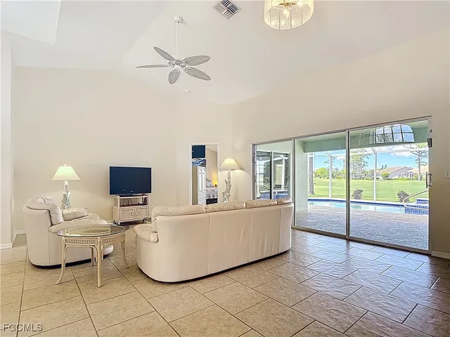 a living room with furniture and a floor to ceiling window