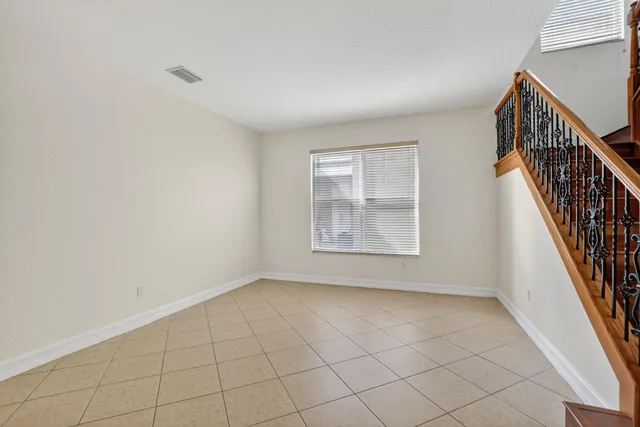 a view of kitchen with stainless steel appliances granite countertop a refrigerator oven a sink and a large window
