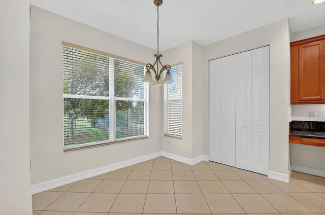a view of an empty room with wooden floor and closet