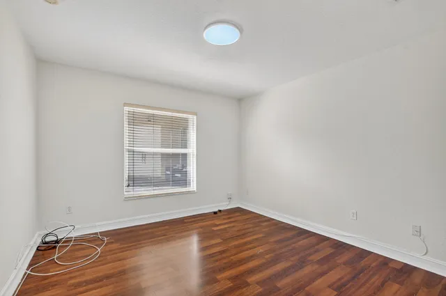 a view of room with wooden floor and ceiling fan
