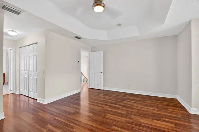 a view of an empty room and wooden floor