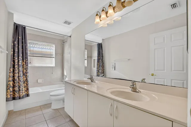 an aerial view of a house with a yard and lake view