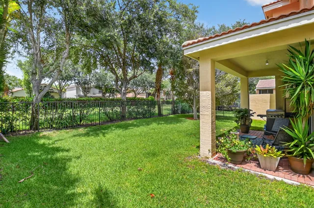 an aerial view of a house with balcony and trees al around