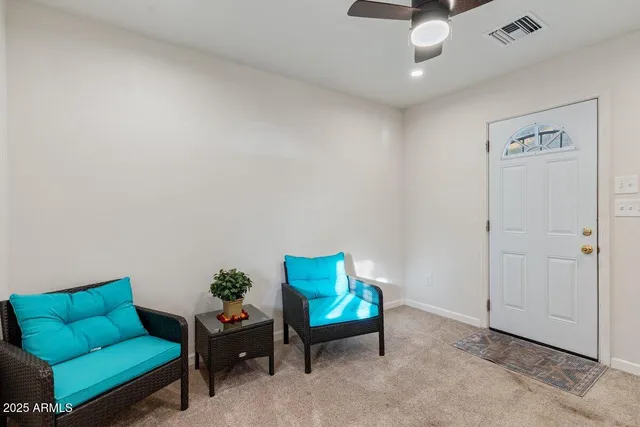a living room with furniture and a rug