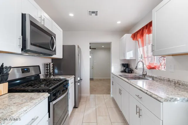 a kitchen with a sink stove and microwave
