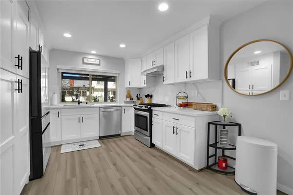 a kitchen with a white cabinets stove and refrigerator