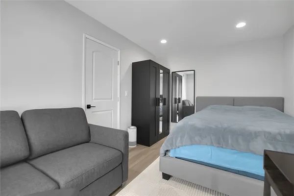 a living room with a couch and a refrigerator