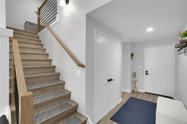 a view of entryway with wooden floor and stairs