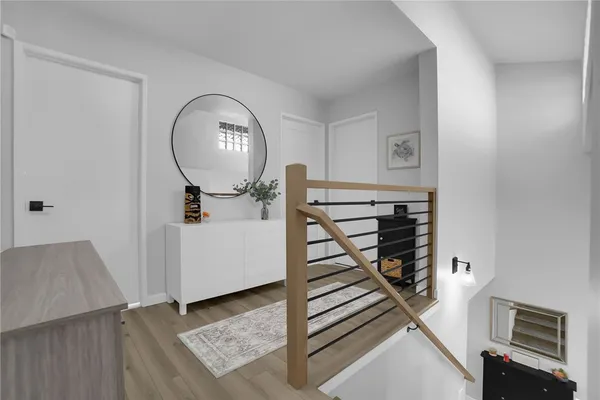 a view of a livingroom with wooden floor and a staircase