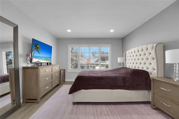 a spacious bedroom with a large bed and a window