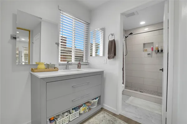 a bathroom with a tub a sink and mirror