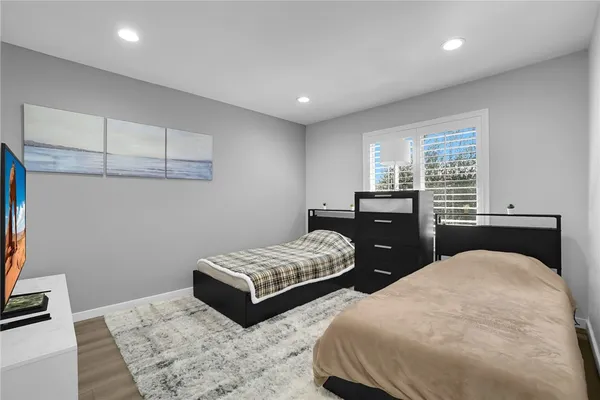 a bedroom with a bed and glass wall