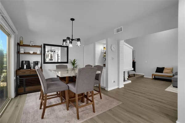 a view of a dining room with furniture and wooden floor