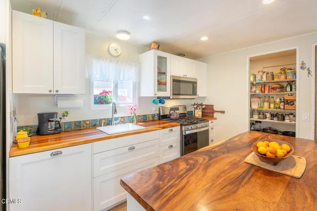 a kitchen with a stove a sink and a refrigerator