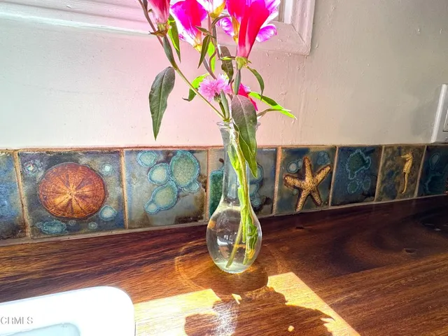 a view of a workspace with furniture and wooden floor