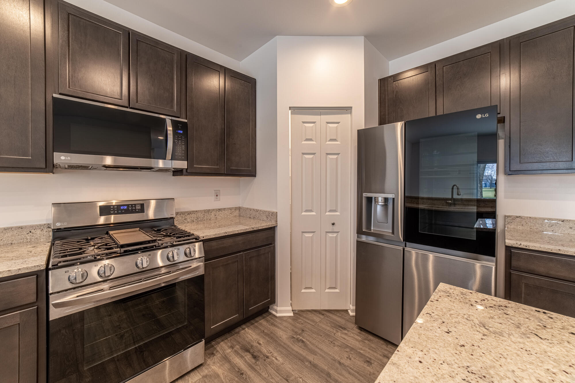 13131 Rutledge Place Crown Point, IN 46307 - Photo 14 of 25 a kitchen with stainless steel appliances and wooden cabinets