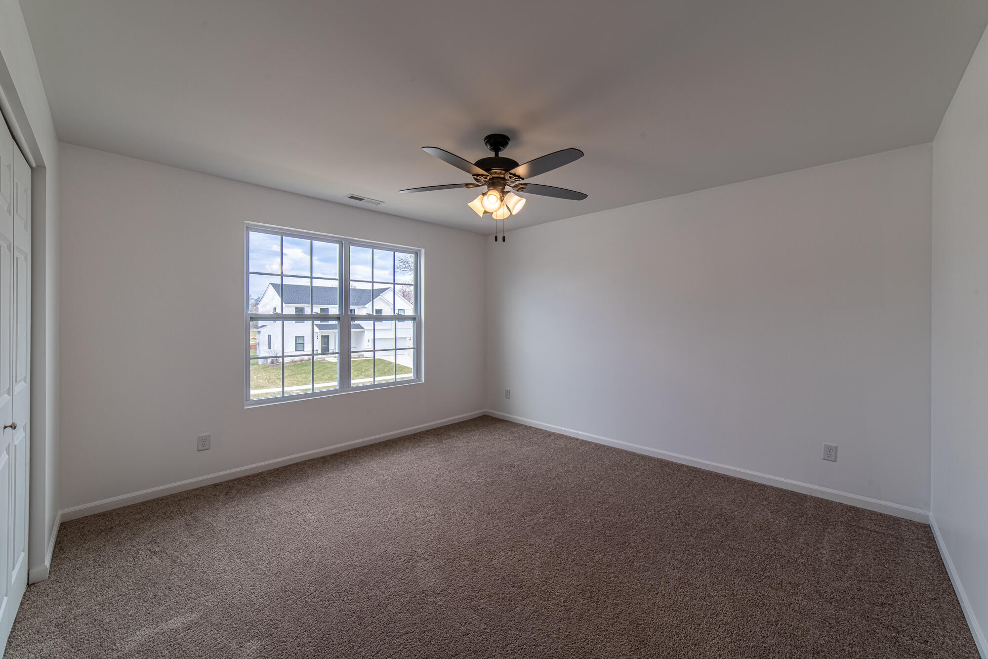 13131 Rutledge Place Crown Point, IN 46307 - Photo 21 of 25 an empty room with chandelier fan and windows