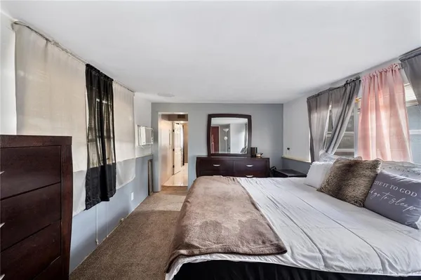 a bedroom with a bed and window
