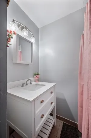 a bathroom with a sink mirror and vanity