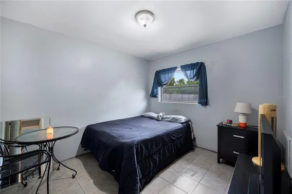 a bedroom with a bed and a table