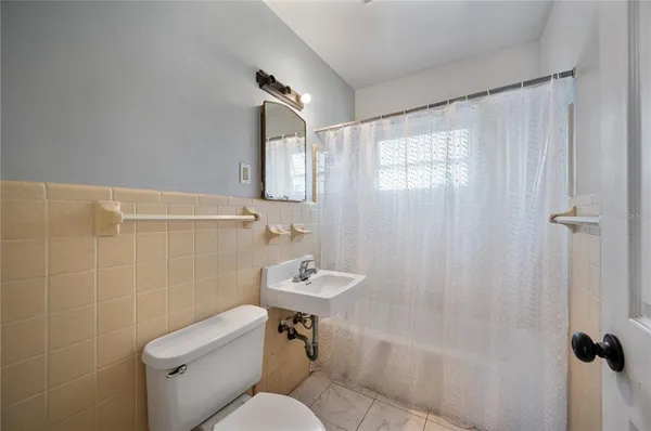 a bathroom with a toilet a sink and shower