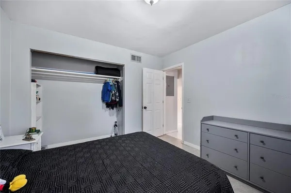 a bedroom with a bed and a dresser