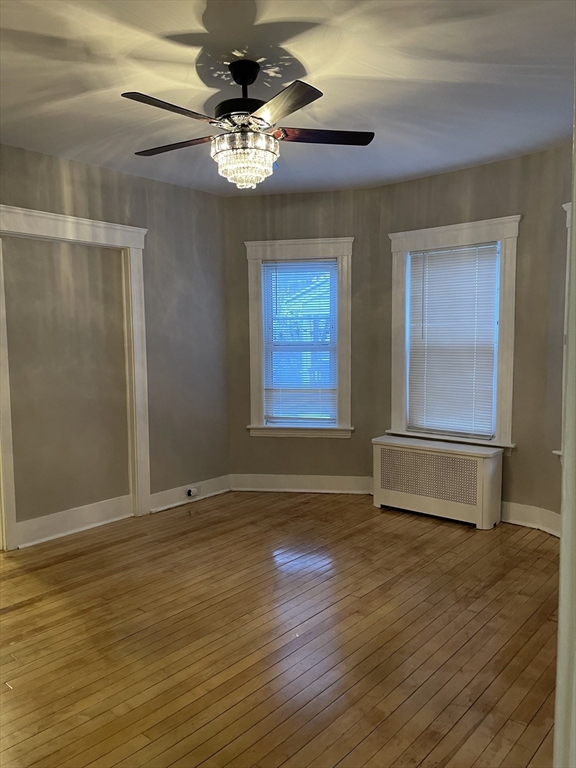 52 Houghton Street, Unit 1 Worcester, MA 01604 - Photo 11 of 15 a view of an empty room with wooden floor and a window