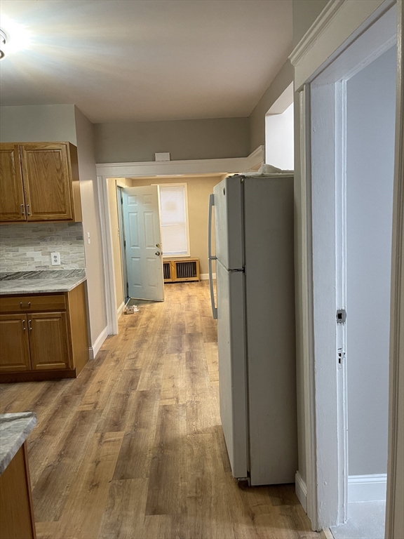 52 Houghton Street, Unit 1 Worcester, MA 01604 - Photo 6 of 15 a kitchen with stainless steel appliances granite countertop a refrigerator and a stove