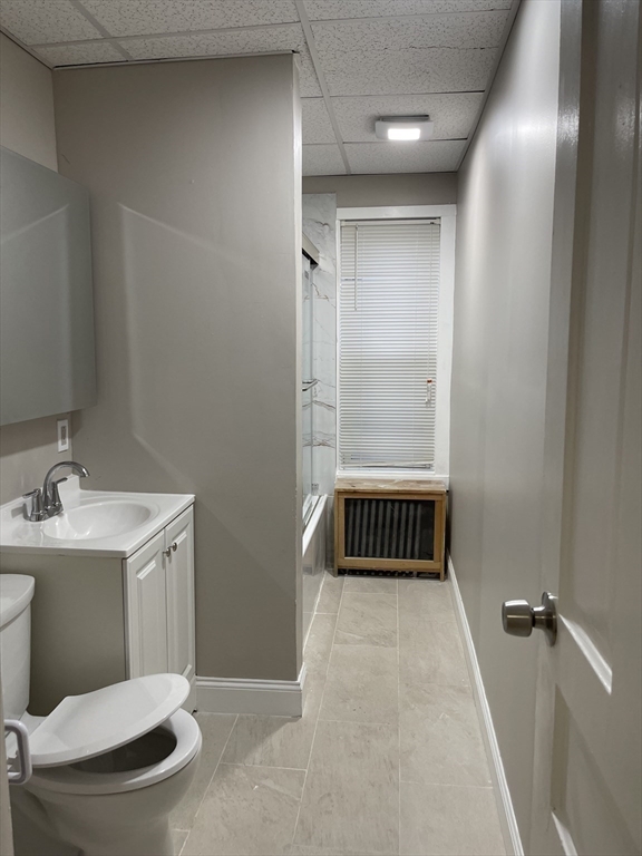 52 Houghton Street, Unit 1 Worcester, MA 01604 - Photo 7 of 15 a bathroom with a sink toilet and shower
