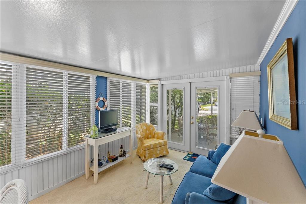 633 Starboard Avenue Edgewater, FL 32141 - Photo 12 of 57 a living room with furniture and large windows