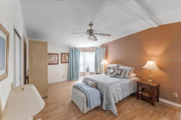 a bedroom with a bed and a chandelier
