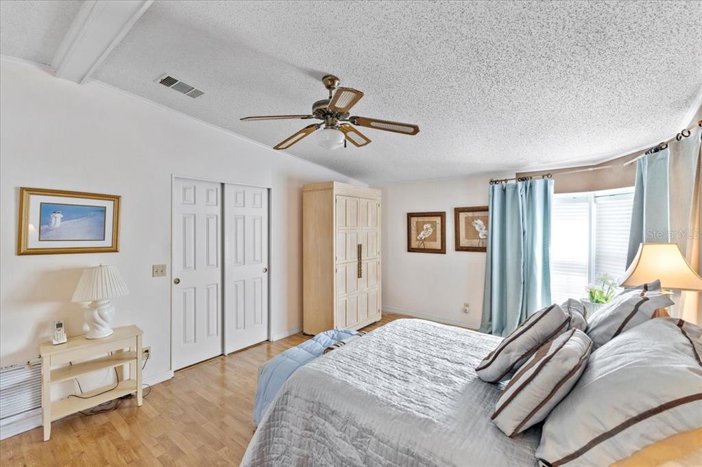633 Starboard Avenue Edgewater, FL 32141 - Photo 18 of 57 a bedroom with a bed and a chandelier