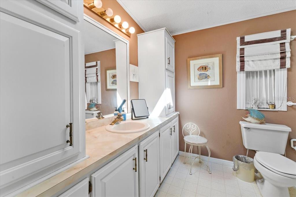633 Starboard Avenue Edgewater, FL 32141 - Photo 20 of 57 a bathroom with a granite countertop sink mirror and toilet