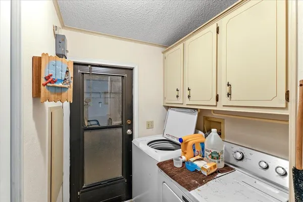a view of a refrigerator in kitchen and a window