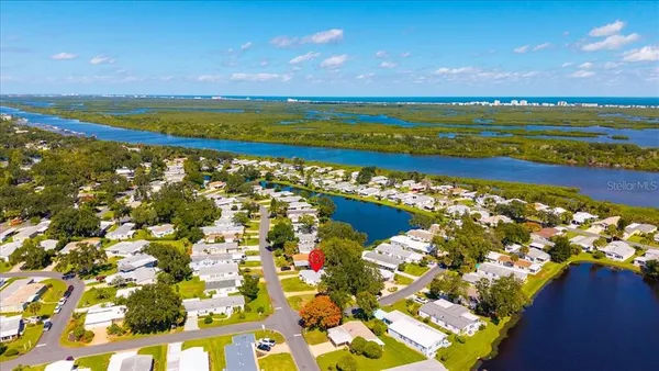 an aerial view of a house with a yard and swimming pool
