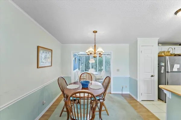 a view of a dining room with furniture and chandelier
