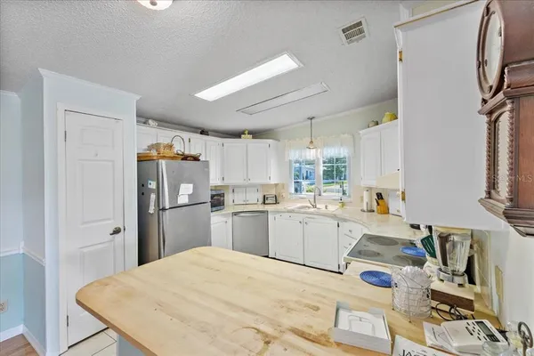 a kitchen with refrigerator and window