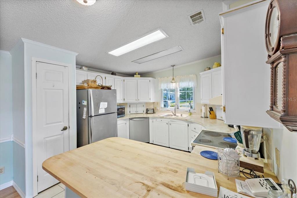 633 Starboard Avenue Edgewater, FL 32141 - Photo 8 of 57 a kitchen with refrigerator and window