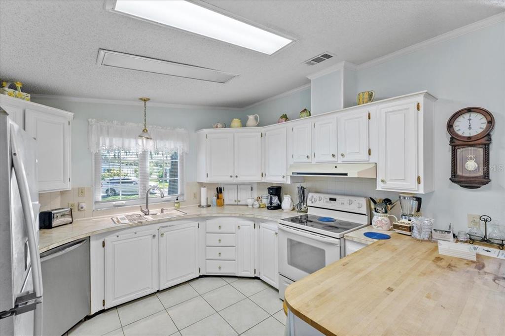 633 Starboard Avenue Edgewater, FL 32141 - Photo 10 of 57 a kitchen with cabinets appliances a sink and a window