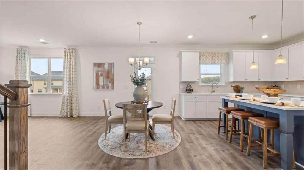 1770 Goodwin Drive Hampton, GA 30228 - Photo 24 of 79 a kitchen with kitchen island stainless steel appliances a table and chairs in it