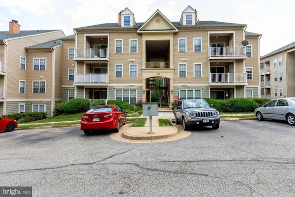 a car parked in front of a brick house with a yard