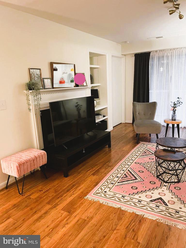 1043 Gardenview Loop, Unit 203 Woodbridge, VA 22191 - Photo 4 of 7 a living room with furniture and a rug