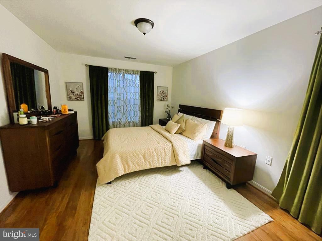 1043 Gardenview Loop, Unit 203 Woodbridge, VA 22191 - Photo 7 of 7 a bedroom with a bed and flat screen tv