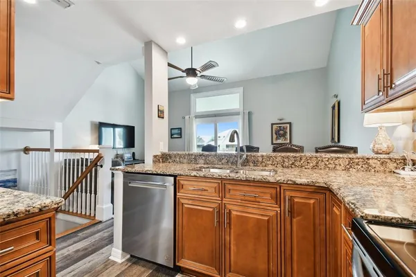 a kitchen with stainless steel appliances granite countertop a sink and stove