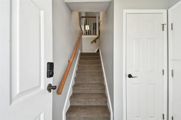 a view of a hallway with wooden floor and entryway