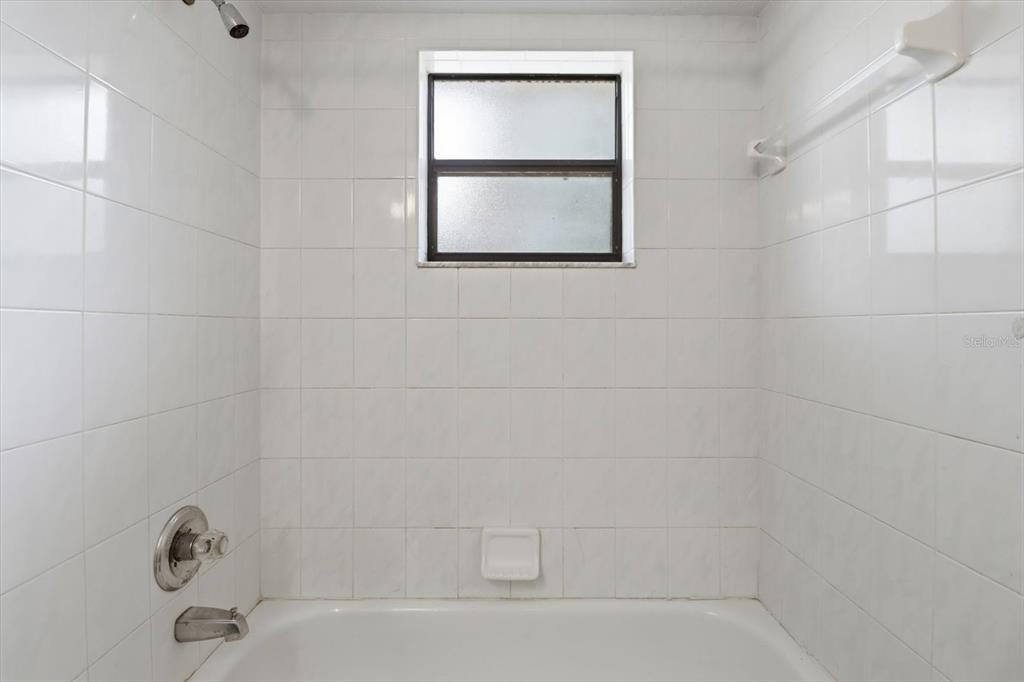 6355 East Rush Street Inverness, FL 34452 - Photo 17 of 27 a bathroom with a bathtub and a shower