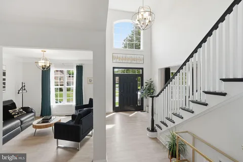 a living room with fireplace furniture and a window