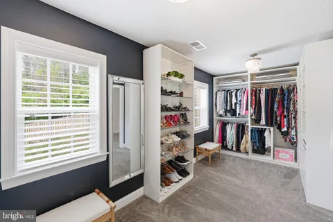 a view of a livingroom with workspace and a window