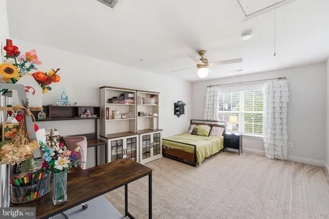 a bed room with a bed and a chair